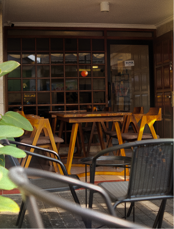 COCA cafe interior with wooden tables and warm lighting in Salatiga